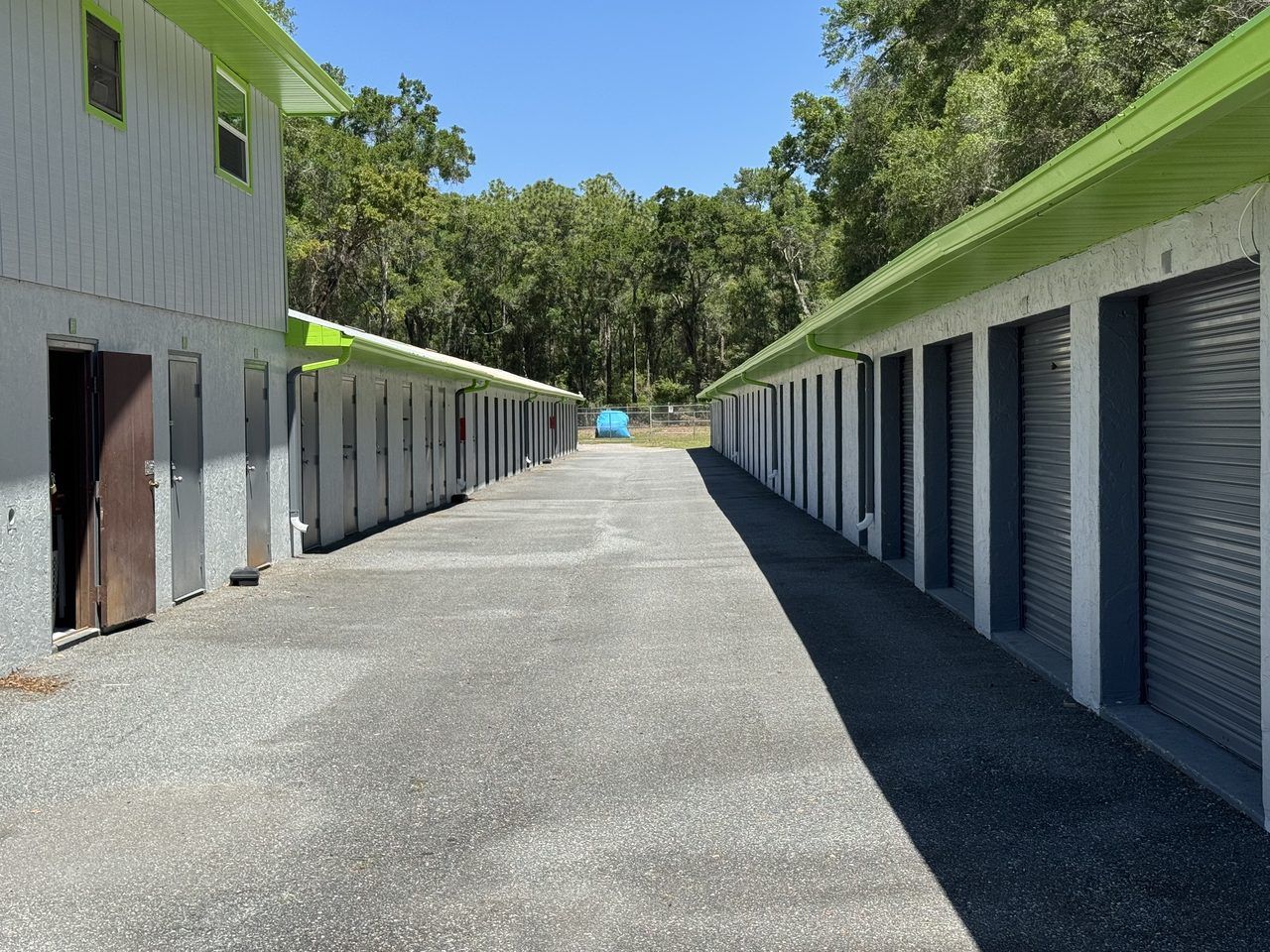 Drive aisle at Cortez Self Storage in Brooksville, FL — bright lighting illuminating concrete-block storage units along Cortez Blvd.