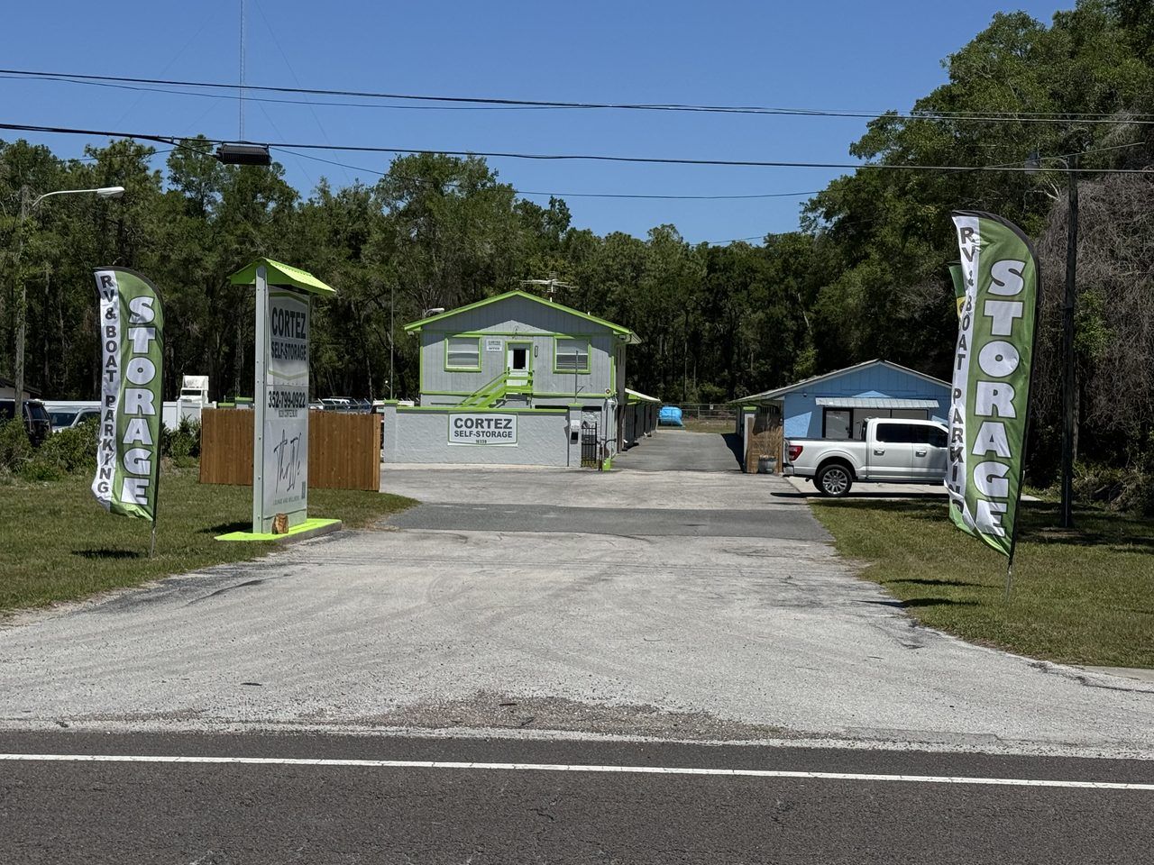 Entrance to Cortez Self Storage at 16339 Cortez Blvd in Brooksville, FL — Cortez Self-Storage pylon sign, RV & boat parking banner, and the office building visible from Cortez Blvd.