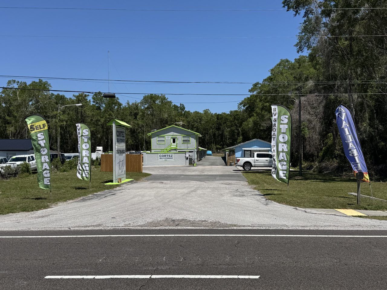 Street view of Cortez Self Storage entrance at 16339 Cortez Blvd in Brooksville, FL &mdash; pylon sign, office building, and feather flags visible from the road.