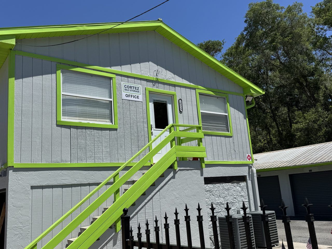 The Cortez Self-Storage office at 16339 Cortez Blvd in Brooksville, FL &mdash; lime-green-trimmed building where the on-site manager works Tuesday through Saturday.